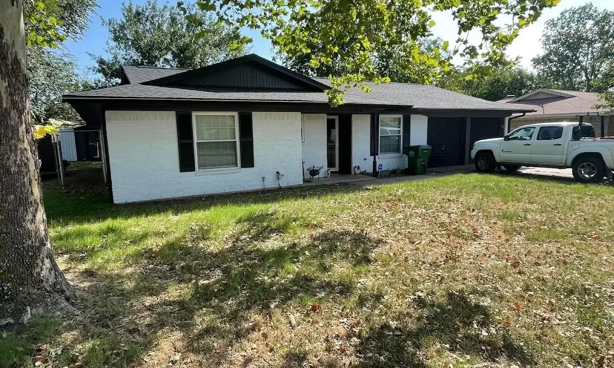 Professional roofing crew working on a residential roof in Salina